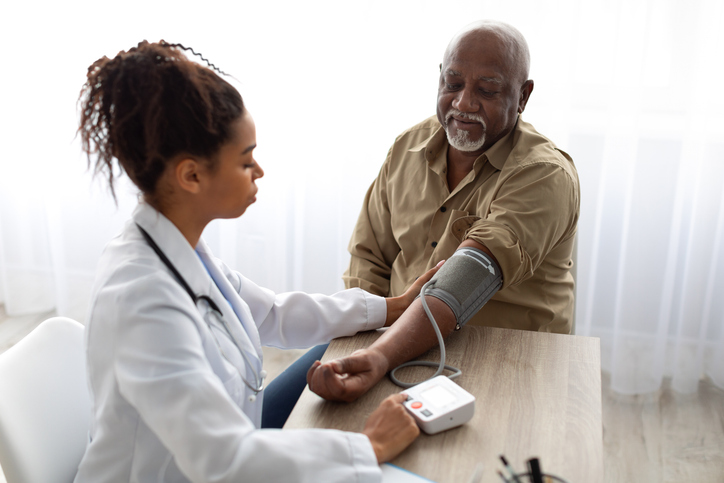 A patient getting their blood pressure checked by a provider