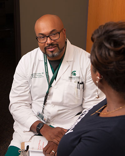 Craig Cole speaks to a female patient