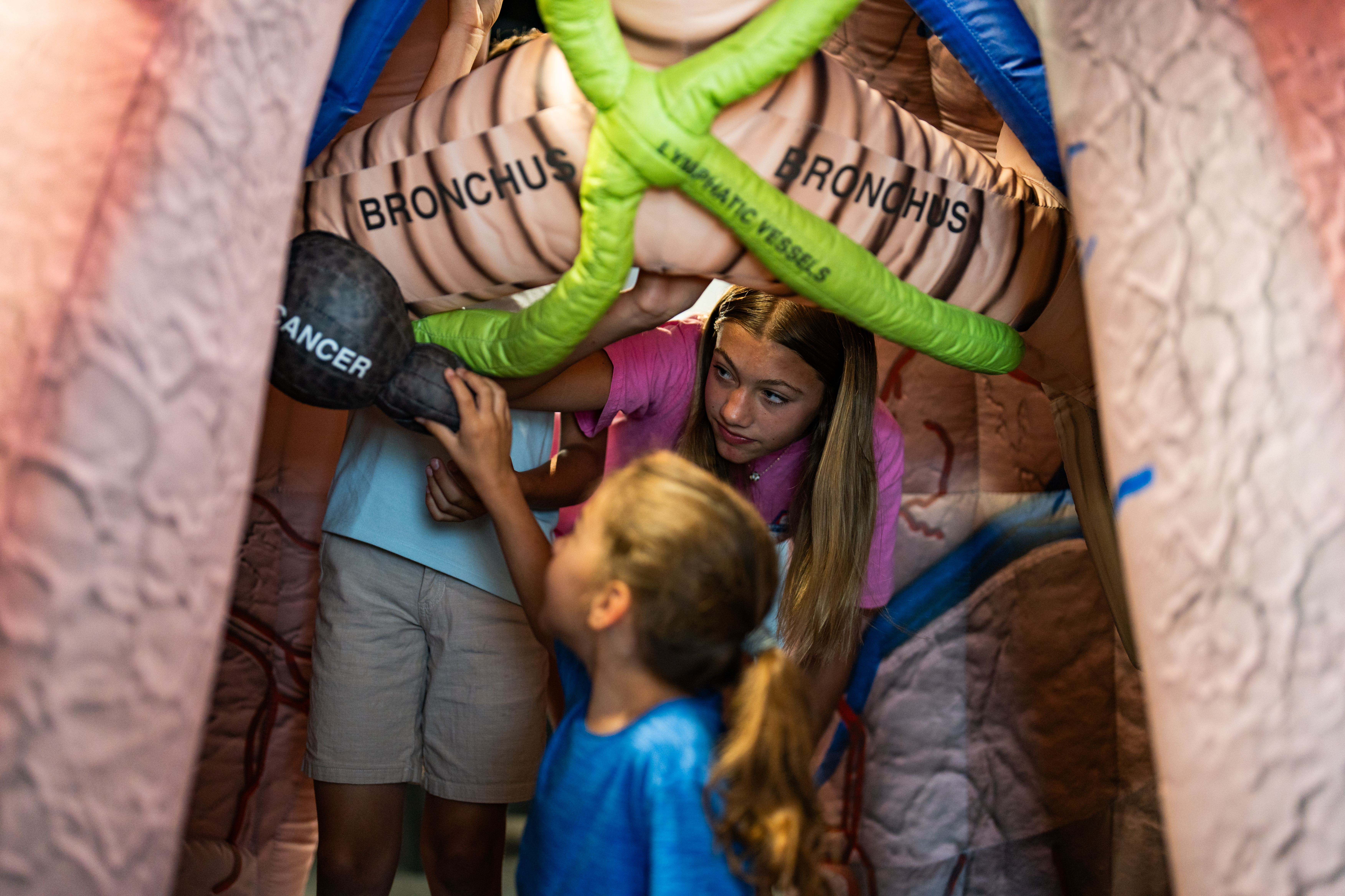 kids exploring the mega-mini lung medical inflatable exhibit